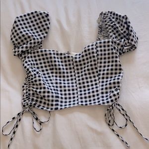 Likely black and white checkered top